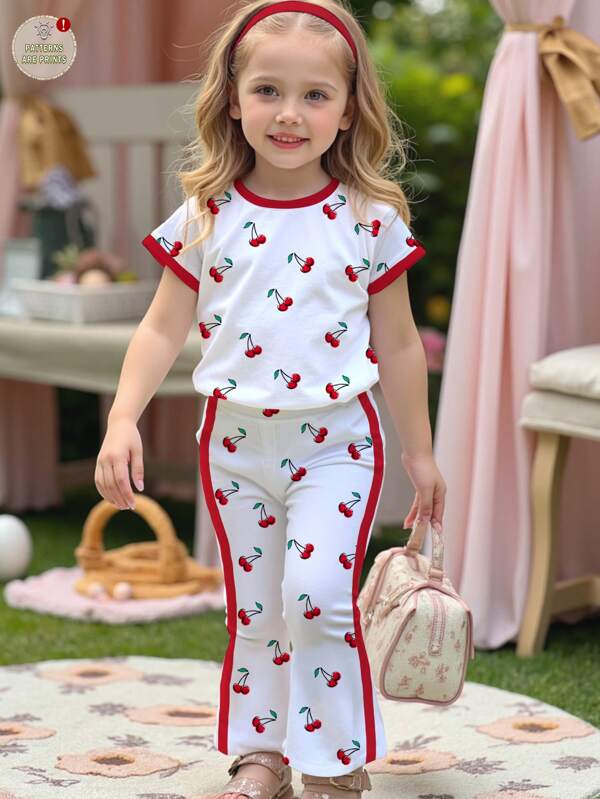 SHEIN Conjunto de 2 piezas de top de manga corta con cuello redondo y pantalones acampanados con estampado de cerezas en estilo retro americano casual, adecuado para el verano, para niñas jóvenes