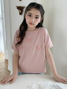 Hapijoa Camiseta casual de manga corta con cuello redondo y decoración de lazo para niña preadolescente, ideal para el verano y el regreso a clases - Rosa - Ver 1