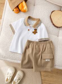 SHEIN Conjunto de 2 peças para bebê menino, fofo e casual, com estampa de urso em blocos de cores, composto por camisa polo de manga curta e shorts com elástico na cintura. Ideal para festas de aniversário, eventos noturnos, apresentações, casamentos, comemorações de 1 mês, batizados e chás de bebê. Roupa de verão para bebê menino. Conjunto de shorts para bebê menino. Camisa polo e shorts para bebê menino. Conjunto de verão para bebê menino. Conjunto de roupas para bebê menino. Shorts cáqui para bebê menino. - Multicolorido - Ver 5