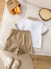 SHEIN Conjunto de 2 peças para bebê menino, fofo e casual, com estampa de urso em blocos de cores, composto por camisa polo de manga curta e shorts com elástico na cintura. Ideal para festas de aniversário, eventos noturnos, apresentações, casamentos, comemorações de 1 mês, batizados e chás de bebê. Roupa de verão para bebê menino. Conjunto de shorts para bebê menino. Camisa polo e shorts para bebê menino. Conjunto de verão para bebê menino. Conjunto de roupas para bebê menino. Shorts cáqui para bebê menino. - Multicolorido - Ver 2