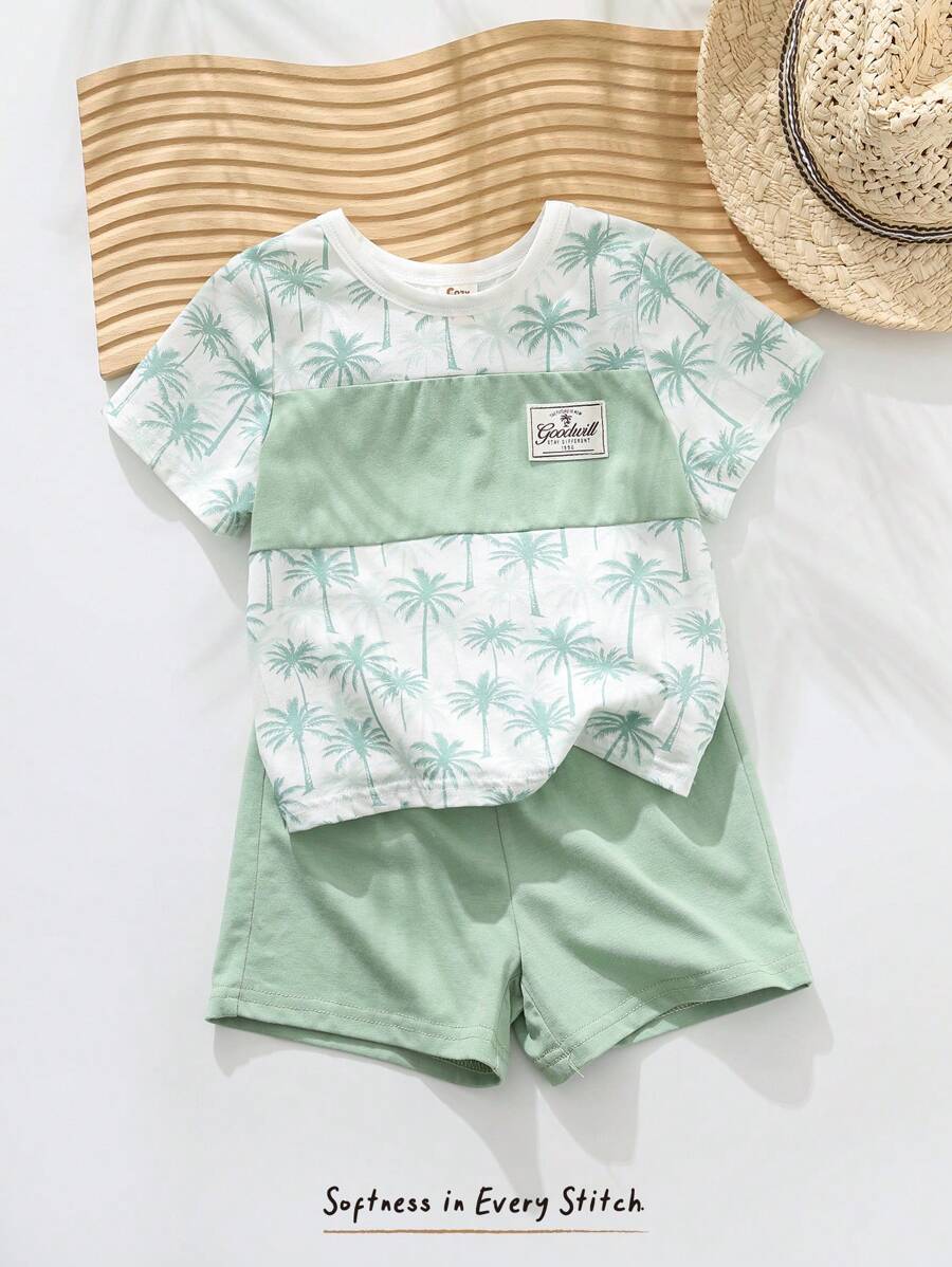 Cozy Pixies طقم (2 قطعة) من ملابس علوية ذو رقبة دائرية وأكمام قصيرة مع طباعة زهور وأشكال نباتية، وشورت خصر مطاطي للأطفال الصغار