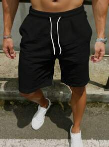 Manfinity Homme Pantalones cortos sólidos relajados de hombre con bolsillos y cordón en la cintura