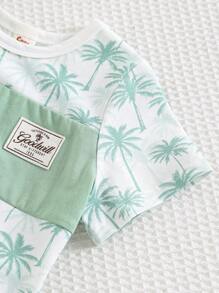 Cozy Pixies طقم (2 قطعة) من ملابس علوية ذو رقبة دائرية وأكمام قصيرة مع طباعة زهور وأشكال نباتية، وشورت خصر مطاطي للأطفال الصغار