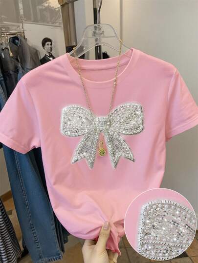 Franclia Camiseta clásica de manga corta y cuello redondo para mujer con elegante moño y decoración con lentejuelas