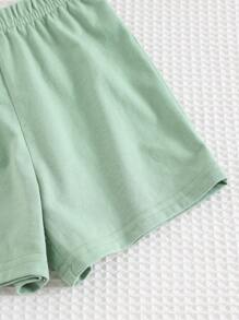 Cozy Pixies طقم (2 قطعة) من ملابس علوية ذو رقبة دائرية وأكمام قصيرة مع طباعة زهور وأشكال نباتية، وشورت خصر مطاطي للأطفال الصغار