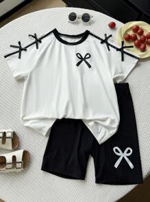 SHEIN 2 件套青少年女孩休闲百搭美式学院风，蝴蝶结装饰节日主题，黑白拼接宽松短袖蝴蝶结印花 T 恤和黑色紧身短裤，适合上学、郊游、度假、春夏季年轻女孩套装夏季