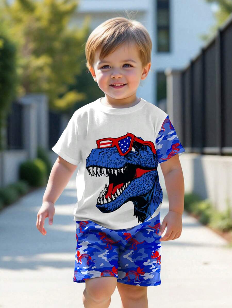 SHEIN 2 件套年轻男孩休闲卡通恐龙图案圆领短袖 T 恤和短裤套装，适合夏季