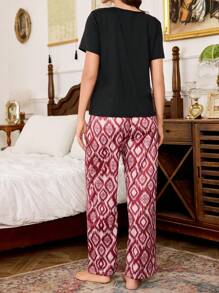 SHEIN Conjunto de pijama para mujer con estampado, de cuello redondo, manga corta y pantalón largo