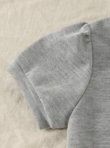 Maglietta girocollo per ragazze con fiocco, in stile semplice e femminile da college, abbinata a una gonna corta. Outfit da college e abbigliamento sportivo per il ritorno a scuola della stagione 2025