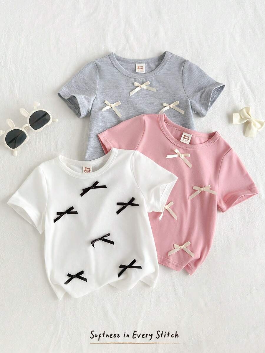 Cozy Pixies Set de 3 blusas de manga corta con cuello de tripulación de punto suave de unicolor para niña bebé, con moño decorativo, camiseta linda - Rosa - Ver 1
