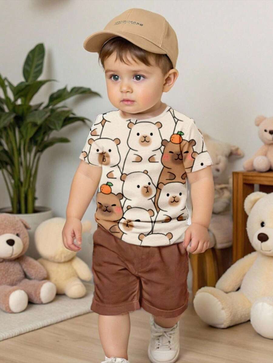 SHEIN Conjunto de 2 piezas de estilo informal para niño bebé con estampado de capibara, delfín de agua y boceto de dibujo animado, compuesto por camiseta de manga corta y pantalón corto de cuello redondo, adecuado para el verano