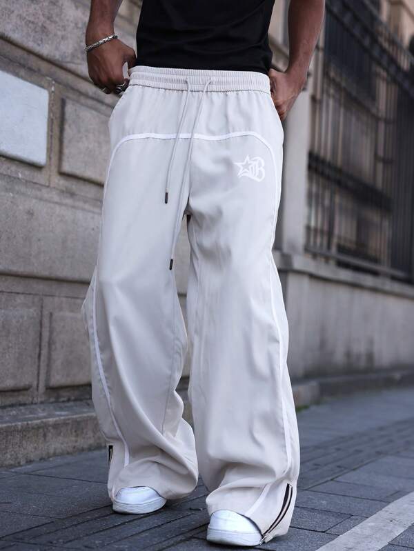 Manfinity Streetrush Pantalones de corte holgado con cremallera y estampado, estilo urbano para hombre