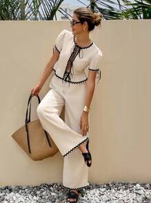SHEIN Frenchy 2pcs Women Fashion Casual Long Pants & Contrasting Edges The Lotus Leaf Puff Sleeves Top Set,Colorblocked Trimmed Front Center Tie Short Sleeve Top And Pants Set,Waist-Slimming Ruffled Hem Design,Fashion And Romantic Commuting,Contrast Edge, Linen-Like Bamboo Pattern Stretch Fabrics,For Daily Wear Summer - Apricot - View 1