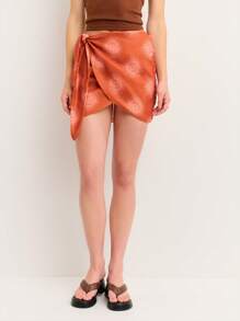 Nöista 提花裹身橙色迷你裙，侧边系带，旭日图案。丝滑质感，不对称剪裁，非常适合沙滩装、圣若昂造型，或大胆的美国独立日造型。