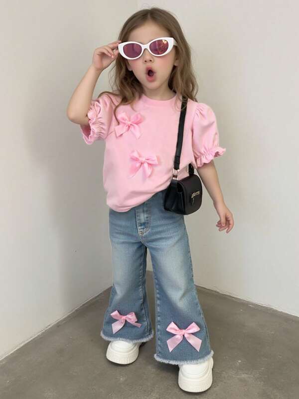 SHEIN Conjunto de niña bebé de verano casual y lindo, con top de manga corta de cuello redondo en color liso con moño 3D y pantalones campana de mezclilla lavada, estilo coreano