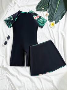 Traje de baño de una pieza con estampado floral para niñas preadolescentes, con cierre de cremallera frontal, manga corta y short negro integrado con patrón de flores estampado a los lados, tipo conjunto de dos piezas