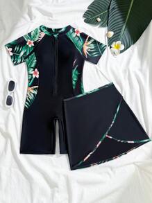 Traje de baño de una pieza con estampado floral para niñas preadolescentes, con cierre de cremallera frontal, manga corta y short negro integrado con patrón de flores estampado a los lados, tipo conjunto de dos piezas