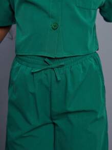 SHEIN Conjunto de camisa de manga corta holgada y casual de unicolor y pantalones anchos para niñas preadolescentes con bolsillos de parche