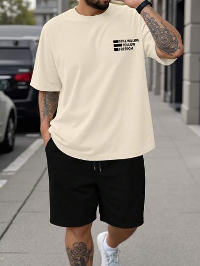 Manfinity Homme 卡其色短袖T恤，印有“依然愿意追随自由”图案，搭配黑色运动短裤，打造清新休闲的穿搭，适合商务通勤和休闲场合。时尚优雅，也是送给男朋友的绝佳礼物。男士短裤套装，大码男士两件套，旅行装。
