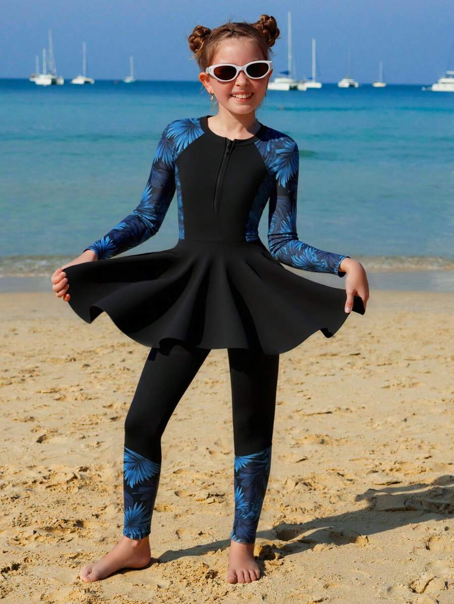 SHEIN Conjunto de 2 piezas de biquini para niñas preadolescentes: Top tipo chaleco sin mangas con estampado floral, cierre con cremallera; Bottom: Falda negra con estampado floral de retazos, traje de baño de dos piezas