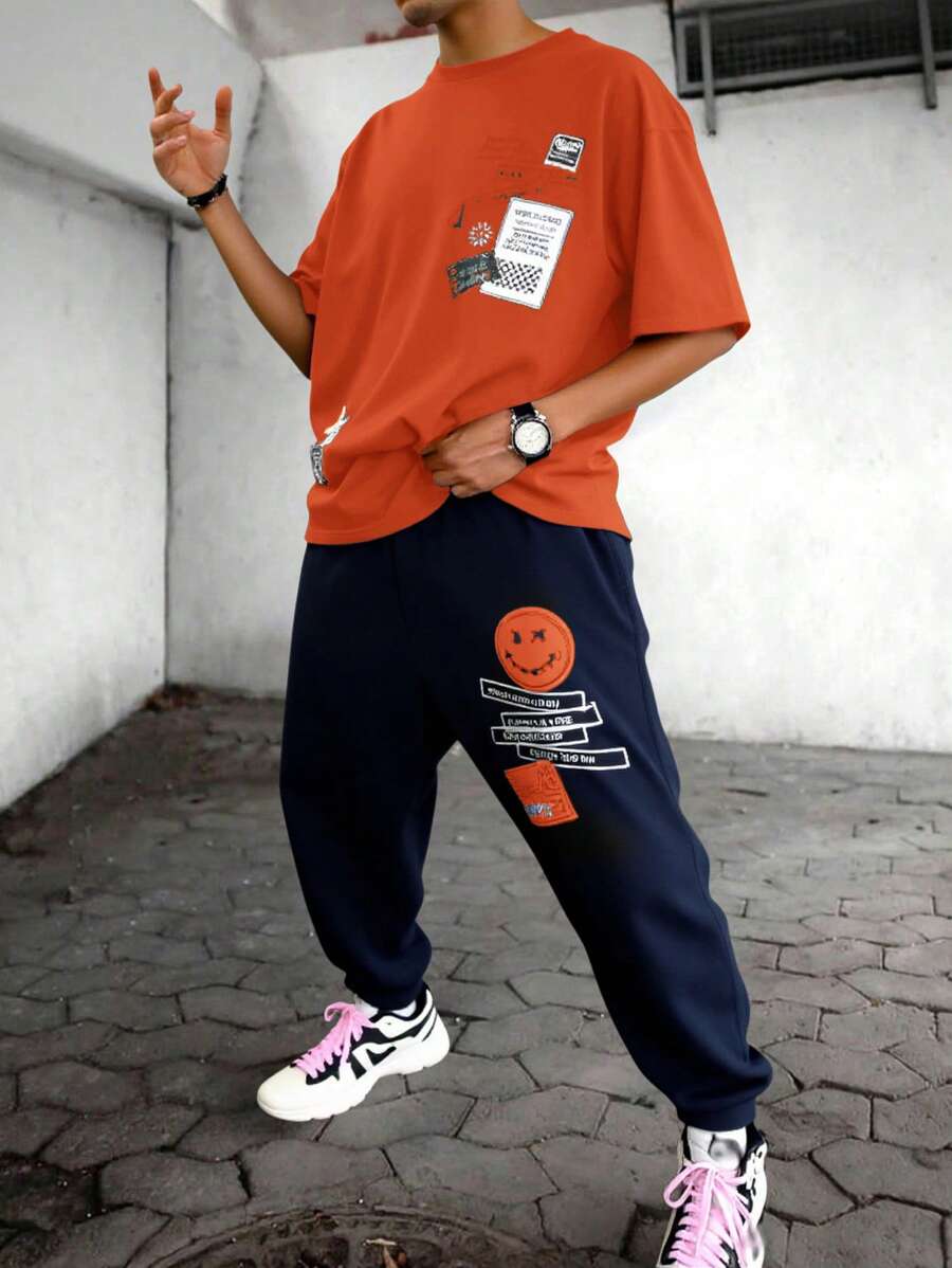 SHEIN 2 件青少年男童休闲短袖 T 恤和裤子套装，街头朋克摇滚学院风日常服装，适合春夏季、派对、音乐节，蓝黑色带英文印花 - 橘色 - 查看 1