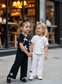 2 piezas Blusa para niñas bebé de unicolor con cuello vuelto y lazo 3D. Con diseño de unicolor que muestra un estilo dulce y lindo. El diseño de cuello vuelto ofrece un aspecto clásico y elegante. Los adornos de lazo 3D en el cuello y el Body incorporan hábilmente elementos dulces y de moda, resaltando las características activas y adorables de las niñas bebé. La silueta ajustada y las líneas suaves favorecen la figura del bebé, emanando confianza y alegría. Adecuado para diversas ocasiones.