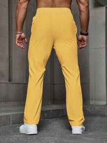 Manfinity Homme Quần dài nam màu trơn có dây rút có túi, quần dài rộng thùng thình, quần đi chơi đơn giản, mùa thu - Màu vàng - Xem 2