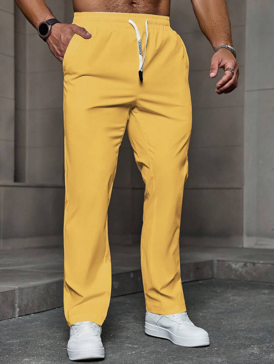 Manfinity Homme Quần dài nam màu trơn có dây rút có túi, quần dài rộng thùng thình, quần đi chơi đơn giản, mùa thu - Màu vàng - Xem 1