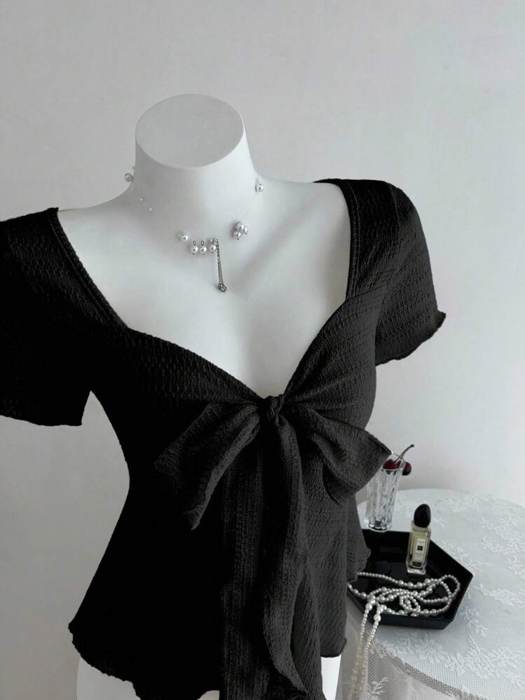 Elamini Nueva camiseta ajustada de manga corta para mujer con cuello en V, lazo y textura, casual y para vacaciones, primavera/verano - Negro - Añade 3