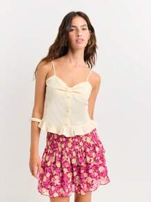 Nöista Débardeur féminin sans manches avec bretelles réglables. Présente une fermeture boutonnée à l'avant, un détail de buste froncé et un ourlet volant - parfait pour les looks d'été ou le chic décontracté.