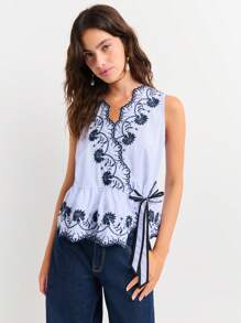 Nöista Sleeveless Wrap Blouse With Floral Embroidery And Scalloped Edges. Peplum Hem, Feminine Silhouette, Elegant, Lace-Style Details, Adjustable Tie Waist, Lightweight, Perfect For Spring, Summer, Or Casual-Chic Looks. - Blue and White - View 7