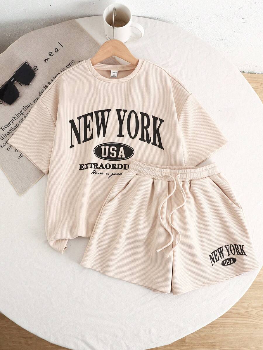 Conjunto de dos piezas para niña preadolescente con camiseta de manga corta de cuello redondo holgada con gráfico de letra y pantalones cortos de estilo informal de punto - Albaricoque - Ver 1