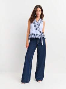 Nöista Sleeveless Wrap Blouse With Floral Embroidery And Scalloped Edges. Peplum Hem, Feminine Silhouette, Elegant, Lace-Style Details, Adjustable Tie Waist, Lightweight, Perfect For Spring, Summer, Or Casual-Chic Looks. - Blue and White - View 6
