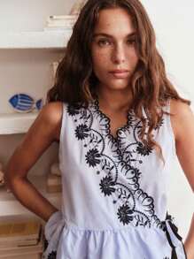 Nöista Sleeveless Wrap Blouse With Floral Embroidery And Scalloped Edges. Peplum Hem, Feminine Silhouette, Elegant, Lace-Style Details, Adjustable Tie Waist, Lightweight, Perfect For Spring, Summer, Or Casual-Chic Looks. - Blue and White - View 5