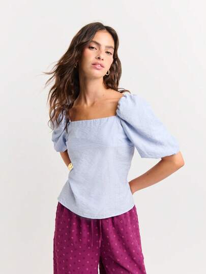 Nöista Stylish Puff-Sleeve Blouse With A Square Neckline And Fitted Bodice. The Open Back Features Adjustable Wrap Ties For A Custom Fit. Elegant Yet Playful-Perfect For Both Casual And Chic Occasions.
