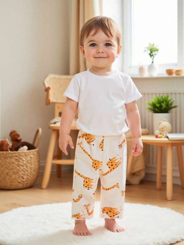 SHEIN Playful Pals Pantalones leggings casuales y cómodos para niños pequeños con estampado de jirafa de dibujos animados y cintura elástica