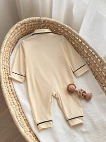 SHEIN Cozy Newborn Baby Apricot Polyester Long Sleeve Pajama. This Collared Button-Front Romper Features An Adorable Cartoon Bear Pocket, Perfect For Infant Everyday Comfort.