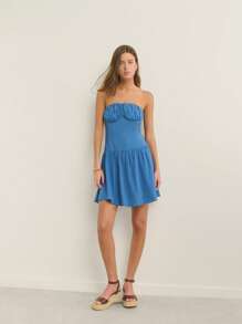 Nöista Fitted Strapless Silhouette Textured Knit Fabric With Ruched Bust And Flared Skirt; Lightweight Breathable Design; Perfect Beach Outfits For Women And Casual Pride Celebration Looks; Versatile Airport Outfit; Summer Essential.