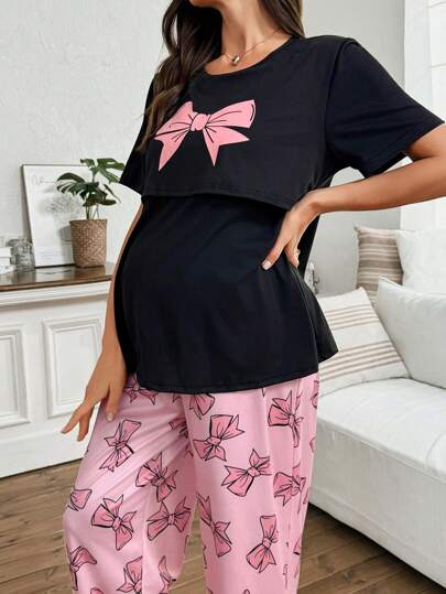 Moonlight&Mama Comfortable Women's Maternity & Nursing Pajama Set. This Black Short Sleeve Round Neck Top Features A Pink Bow And Pairs With Matching Long Pink Bow Print Pants For Casual Sleepwear.