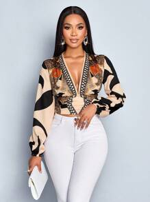 SOLERSUN Autumn/Winter Women's Wear. Casual And Elegant For Everyday Wear. Apricot-Colored Background With Black Floral Print. Woven Fabric. Deep V-Neck. Pleated Waist. Gathered Back. Long Sleeves. Lantern Sleeves. Shirt.