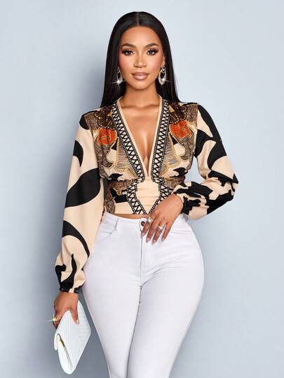 SOLERSUN Autumn/Winter Women's Wear. Casual And Elegant For Everyday Wear. Apricot-Colored Background With Black Floral Print. Woven Fabric. Deep V-Neck. Pleated Waist. Gathered Back. Long Sleeves. Lantern Sleeves. Shirt.