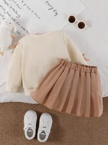SHEIN Playful Pals 女婴两件套休闲甜美风格，黄色长袖运动衫搭配桃色蝴蝶结装饰和浅棕色百褶裙，适合日常穿着、上学、拍照、聚会、春秋季 - 杏色 - 查看 2