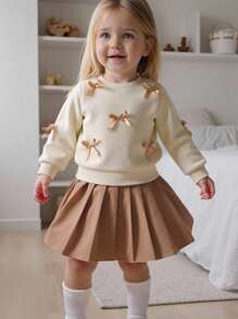 SHEIN Playful Pals 女婴两件套休闲甜美风格，黄色长袖运动衫搭配桃色蝴蝶结装饰和浅棕色百褶裙，适合日常穿着、上学、拍照、聚会、春秋季 - 杏色 - 查看 1