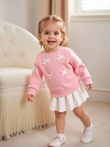 SHEIN Effen sweatshirt met ronde hals en strik voor babymeisjes. Het ronde halsontwerp is klassiek en elegant, waardoor het gemakkelijk aan en uit te trekken is. De lange mouwen en de decoratieve 3D-strik op het lijfje combineren vakkundig de schattige en modieuze elementen, waardoor de levendigheid en speelsheid van het meisje worden benadrukt. Het getailleerde silhouet en de vloeiende lijnen flatteren het figuur van de baby en stralen zelfvertrouwen en geluk uit. Dit sweatshirt is geschikt voor diverse gelegenheden.