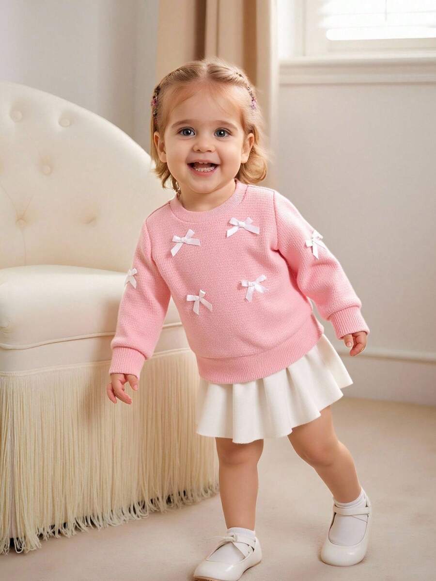 SHEIN Effen sweatshirt met ronde hals en strik voor babymeisjes. Het ronde halsontwerp is klassiek en elegant, waardoor het gemakkelijk aan en uit te trekken is. De lange mouwen en de decoratieve 3D-strik op het lijfje combineren vakkundig de schattige en modieuze elementen, waardoor de levendigheid en speelsheid van het meisje worden benadrukt. Het getailleerde silhouet en de vloeiende lijnen flatteren het figuur van de baby en stralen zelfvertrouwen en geluk uit. Dit sweatshirt is geschikt voor diverse gelegenheden.