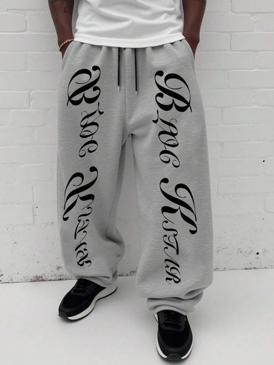 Manfinity EMRG Herren Lässig Buchstaben Muster Jogginghose, Junger Straßen-Stil Herren Graue Jogginghose Weite Graue Jogginghose mit Grafik-Aufdruck, Herren Buchstaben Muster Jogginghose