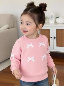 SHEIN Effen sweatshirt met ronde hals en strik voor babymeisjes. Het ronde halsontwerp is klassiek en elegant, waardoor het gemakkelijk aan en uit te trekken is. De lange mouwen en de decoratieve 3D-strik op het lijfje combineren vakkundig de schattige en modieuze elementen, waardoor de levendigheid en speelsheid van het meisje worden benadrukt. Het getailleerde silhouet en de vloeiende lijnen flatteren het figuur van de baby en stralen zelfvertrouwen en geluk uit. Dit sweatshirt is geschikt voor diverse gelegenheden.