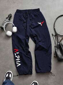 Manfinity Sport Corelite Pantalones largos informales de hombre con cintura elástica con cordón y estampado