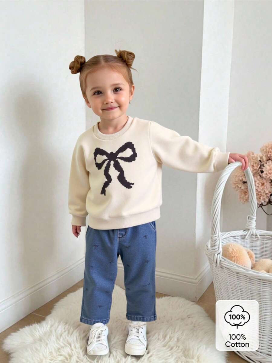 SHEIN Baby Girl 2 Pieces Set,Apricot White Round Neck Long Sleeve Sweatshirt,Graphic Black Bow Print,Blue Denim Pants,Cute Autumn Back-To-School Casual Wear - Apricot - View 1