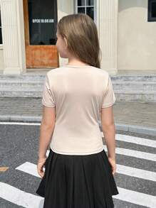 Camiseta informal y elegante de estilo francés para niñas preadolescentes, de punto sólido con un diseño de giro asimétrico en la parte delantera y un hombro asimétrico, perfecta para volver al colegio